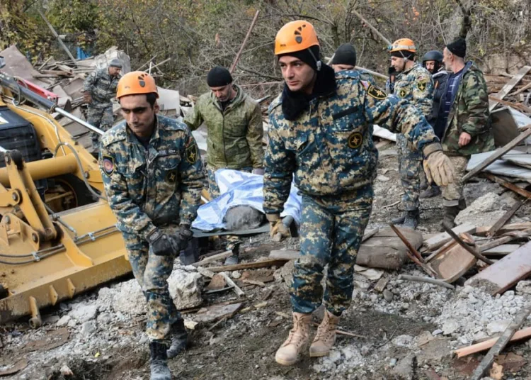 SENSITIVE MATERIAL. THIS IMAGE MAY OFFEND OR DISTURB. Rescuers carry the body of a victim following what is said to be recent shelling in the city of Stepanakert during a military conflict over the breakaway region of Nagorno-Karabakh, in this handout photo released November 6, 2020. Armenian Unified Infocentre/Handout via REUTERS ATTENTION EDITORS - THIS IMAGE HAS BEEN SUPPLIED BY A THIRD PARTY. NO RESALES. NO ARCHIVES. MANDATORY CREDIT.