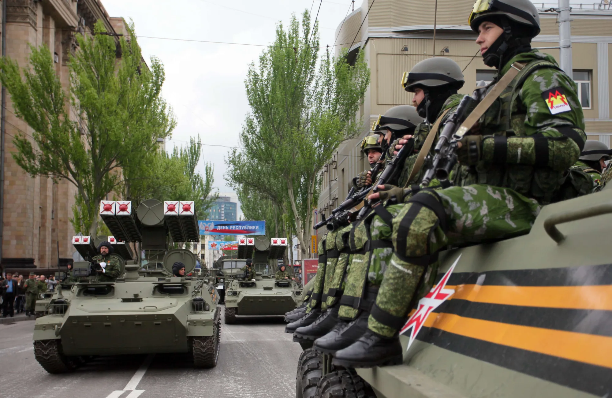 Pro-Russian separatists of the self-proclaimed Donetsk People's Republic sit atop a self-propelled gun during the Victory Day parade in Donetsk on May 9, 2015. Tanks and rocket systems rolled through the rebel bastion of Donetsk in east Ukraine on May 9 as pro-Russian insurgents celebrated the 70th anniversary of the Soviet win over Nazi Germany in WWII. Imitating a vast military parade being held simultaneously in Moscow, some 1,500 separatist fighters marched through the rebel-held city clutching red Soviet flags and portraits of Stalin.