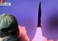 A man watches a television report showing a news broadcast with file footage of a North Korean missile test, at a railway station in Seoul on October 19, 2021, after the South's military said a North Korean weapons test was believed to be a submarine-launched ballistic missile. (Photo by Anthony WALLACE / AFP) (Photo by ANTHONY WALLACE/AFP via Getty Images)