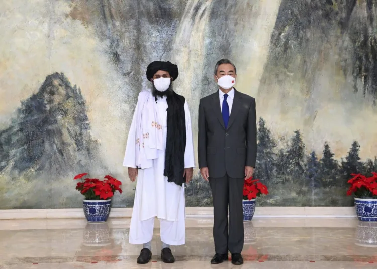 In this photo released by China’s Xinhua News Agency, Taliban co-founder Mullah Abdul Ghani Baradar, left, and Chinese Foreign Minister Wang Yi pose for a photo during their meeting in Tianjin, China, Wednesday, July 28, 2021. China's foreign minister has met with a delegation of high-level Taliban officials as ties between them warm ahead of the U.S. pullout from Afghanistan. (Li Ran/Xinhua via AP)