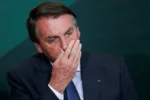 FILE PHOTO: Brazil's President Jair Bolsonaro reacts during the launching ceremony of the National Green Growth Program, at the Planalto Palace in Brasilia, Brazil October 25, 2021. REUTERS/Adriano Machado/File Photo