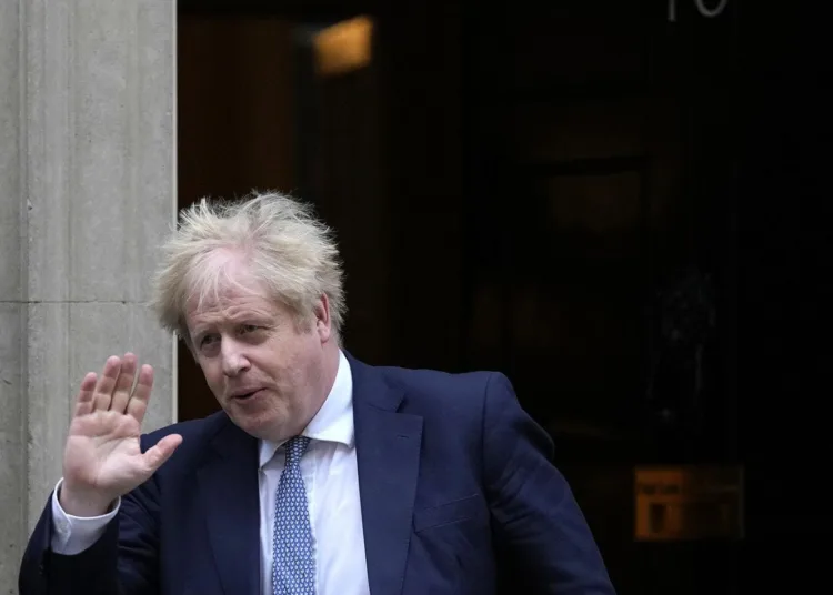 Britain's Prime Minister Boris Johnson leaves 10 Downing Street for the House of Commons for his weekly Prime Minister's Questions in London, Wednesday, Feb. 2, 2022. (AP Photo/Alastair Grant)