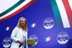 Leader of Brothers of Italy Giorgia Meloni looks on as she walks on the stage at the party's election night headquarters, in Rome, Italy September 26, 2022. REUTERS/Guglielmo Mangiapane