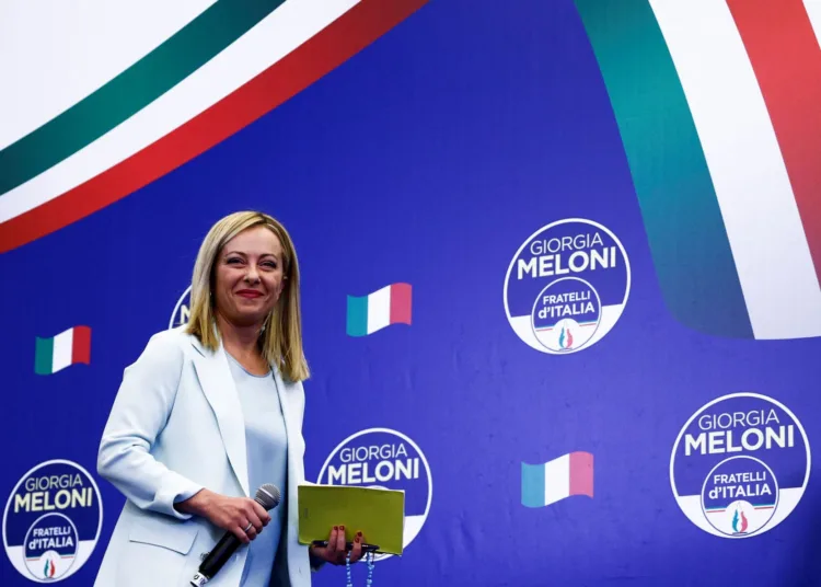 Leader of Brothers of Italy Giorgia Meloni looks on as she walks on the stage at the party's election night headquarters, in Rome, Italy September 26, 2022. REUTERS/Guglielmo Mangiapane