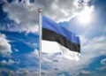 Realistic flag. 3D illustration. Colored waving flag of Estonia on sunny blue sky background.