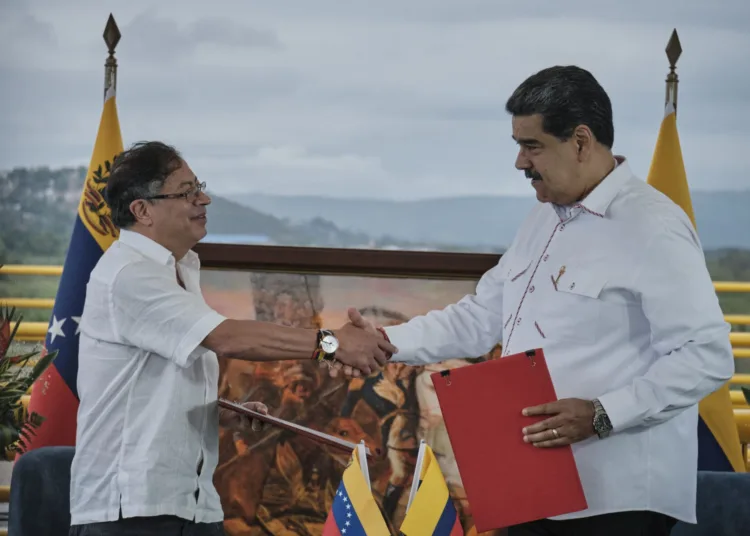 Gustavo Petro, Colombia's president, left, and Nicolas Maduro, Venezuela's president, shake hands during a meeting at the Tienditas International Bridge in Cucuta, Colombia, on Thursday, Feb. 16, 2023. During the meeting near the border, the heads of state signed a memorandum of understanding focused on modernizing trade rules between Colombia and Venezuela. Photographer: Ferley Ospina/Bloomberg via Getty Images