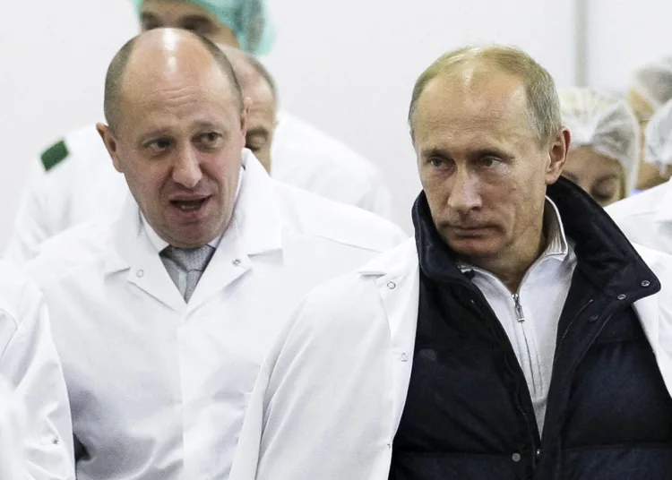 FILE - Businessman Yevgeny Prigozhin, left, shows Russian President Vladimir Putin, around his factory which produces school means, outside St. Petersburg, Russia on Sept. 20, 2010. Prigozhin, the millionaire owner of the Wagner Group private military company, has used his longtime ties with Russian President Vladimir Putin to increase his clout. (Sputnik, Kremlin Pool Photo via AP, File)