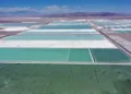 Aerial view of brine ponds and processing areas of the lithium mine of the Chilean company SQM (Sociedad Quimica Minera) in the Atacama Desert, Calama, Chile, on September 12, 2022. - The turquoise glimmer of open-air pools meets the dazzling white of a seemingly endless salt desert where hope and disillusionment collide in Latin America's "lithium triangle." A key component of batteries used in electric cars, demand has exploded for the "white gold" found in Argentina, Bolivia and Chile in quantities larger than anywhere else in the world. (Photo by Martin BERNETTI / AFP)