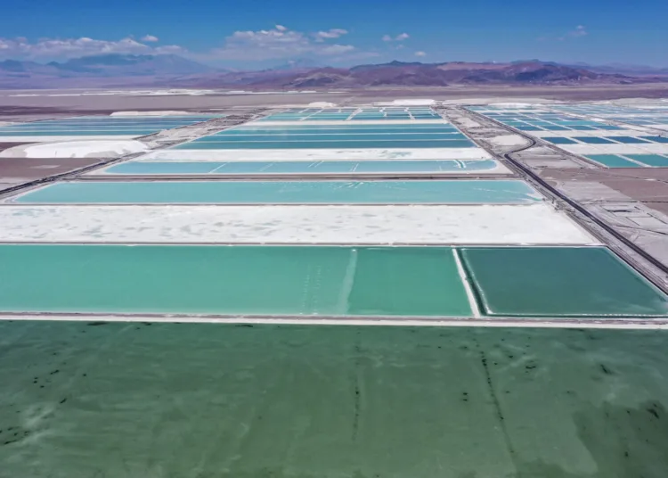 Aerial view of brine ponds and processing areas of the lithium mine of the Chilean company SQM (Sociedad Quimica Minera) in the Atacama Desert, Calama, Chile, on September 12, 2022. - The turquoise glimmer of open-air pools meets the dazzling white of a seemingly endless salt desert where hope and disillusionment collide in Latin America's "lithium triangle." A key component of batteries used in electric cars, demand has exploded for the "white gold" found in Argentina, Bolivia and Chile in quantities larger than anywhere else in the world. (Photo by Martin BERNETTI / AFP)