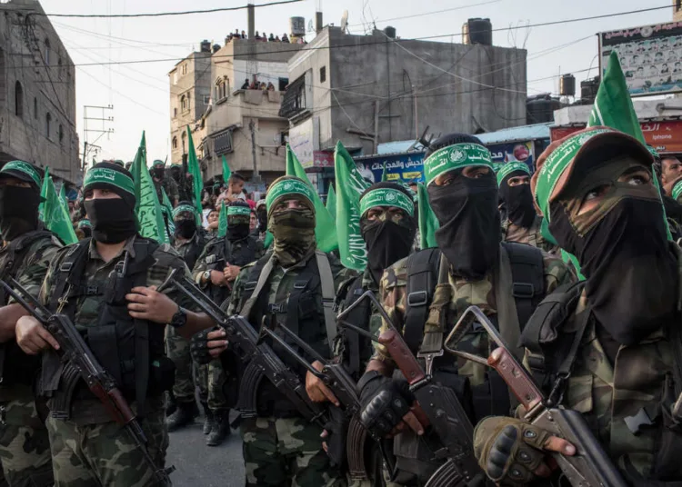 GAZA CITY, GAZA - JULY 20: Palestinian Hamas militants are seen during a military show in the Bani Suheila district on July 20, 2017 in Gaza City, Gaza. For the past ten years Gaza residents have lived with constant power shortages, in recent years these cuts have worsened, with supply of regular power limited to four hours a day. On June 11, 2017 Israel announced a new round of cuts at the request of the Palestinian authorities and the decision was seen as an attempt by President Mahmoud Abbas to pressure Gaza's Hamas leadership. Prior to the new cuts Gaza received 150 megawatts per day, far below it's requirements of 450 megawatts. In April, Gaza's sole power station which supplied 60 megawatts shut down, after running out of fuel, the three lines from Egypt, which provided 27 megawatts are rarely operational, leaving Gaza reliant on the 125 megawatts supplied by Israel's power plant. The new cuts now restrict electricity to three hours a day severely effecting hospital patients with chronic conditions and babies on life support. During blackout hours residents use private generators, solar panels and battery operated light sources to live. June 2017 also marked ten years since Israel began a land, sea and air blockade over Gaza. Under the blockade, movement of people and goods is restricted and exports and imports of raw materials have been banned. The restrictions have virtually cut off access for Gaza's two million residents to the outside world and unemployment rates have skyrocketed forcing many people into poverty and leaving approximately 80% of the population dependent on humanitarian aid. (Photo by Chris McGrath/Getty Images)