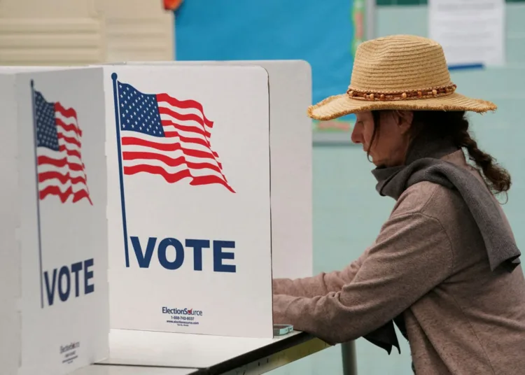 A voter casts her ballot at a polling station on Election Day in Falls Church, Virginia, U.S., November 7, 2023. REUTERS/Kevin Lamarque/ File photo