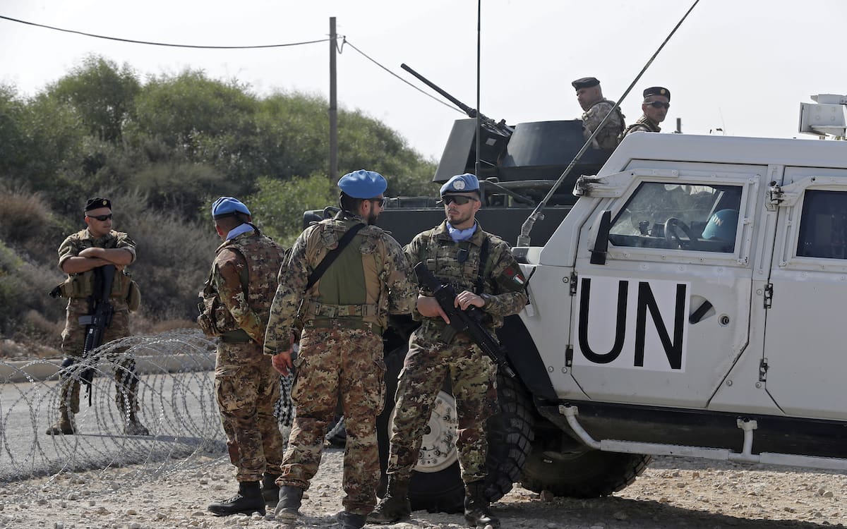 (L to R) Lebanese army soldiers and peacekeepers of the United Nations Interim Force In Lebanon (UNIFIL) are stationed in Lebanon's southern Naqoura along the border with northern Israel's Rosh HaNikra on October 27, 2022. - Lebanon and Israel are expected to sign their maritime deal today, following lengthy negotiations mediated by Washington. (Photo