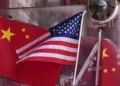 China and U.S. national flags are seen on display on an entrance door of a souvenir shop in Beijing on April 3, 2025. (AP Photo/Andy Wong)