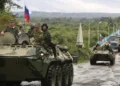 Russian soldiers sit atop armored vehicles as they cross a bridge over the Inguri River as Russian troops pull out from an area outside Georgia's breakaway province of Abkhazia, Wednesday, Oct. 8, 2008. Moscow must withdraw its troops from buffer zones surrounding the two regions by Friday under cease-fire agreements brokered by French President Nicolas Sarkozy in the wake of the August war. (AP Photo/Vladimir Popov)
