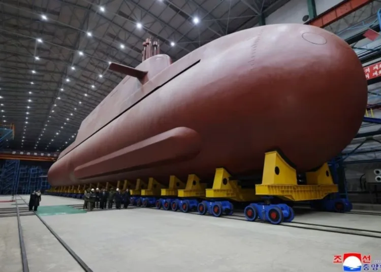 North Korea's leader Kim Jong Un inspected the country's nuclear-powered submarine, claimed to be 8,700 ton, as he called Seoul's nuclear-powered submarine development plan "an offensive act" KCNA