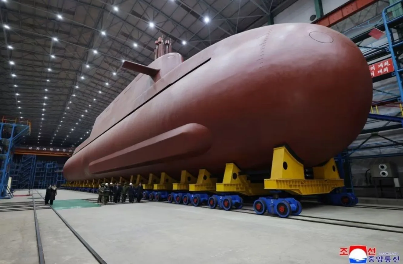 North Korea's leader Kim Jong Un inspected the country's nuclear-powered submarine, claimed to be 8,700 ton, as he called Seoul's nuclear-powered submarine development plan "an offensive act" KCNA