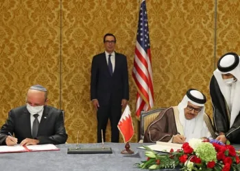 US Treasury Secretary Steve Mnuchin (C) attends a signing ceremony between the head of the Israeli delegation, National Security Advisor Meir Ben Shabbat (L) and Bahraini Foreign Minister Abdullatif bin Rashid Al-Zayani, in the Bahraini capital Manama, on October 18, 2020. - Israel and Bahrain formalised in Manama a US-brokered agreement they signed at the White House on September 15, officially establishing diplomatic relations. (Photo by RONEN ZVULUN / POOL / AFP)