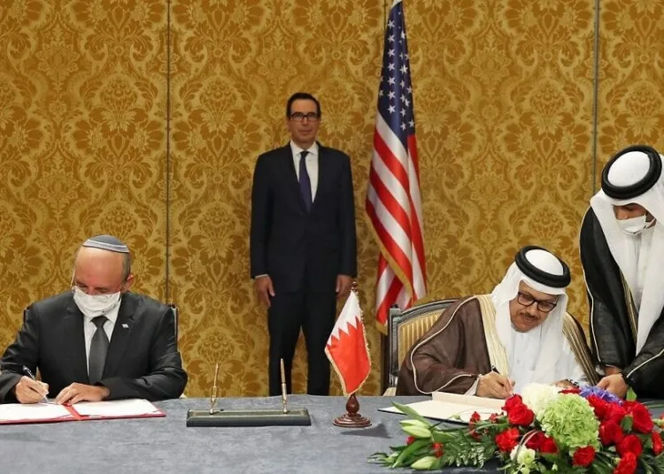 US Treasury Secretary Steve Mnuchin (C) attends a signing ceremony between the head of the Israeli delegation, National Security Advisor Meir Ben Shabbat (L) and Bahraini Foreign Minister Abdullatif bin Rashid Al-Zayani, in the Bahraini capital Manama, on October 18, 2020. - Israel and Bahrain formalised in Manama a US-brokered agreement they signed at the White House on September 15, officially establishing diplomatic relations. (Photo by RONEN ZVULUN / POOL / AFP)