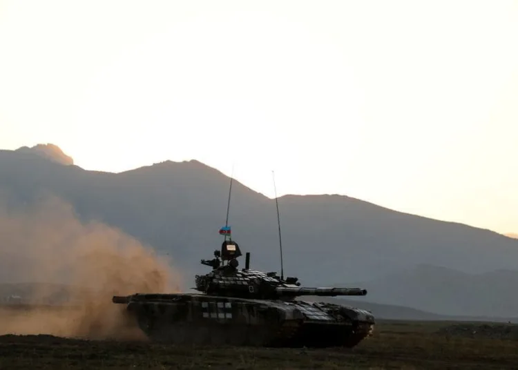 FILE PHOTO: Azerbaijani soldiers maneuver with a tank during a training at a military training and deployment center near the city of Ganja, Azerbaijan October 23, 2020. REUTERS/Umit Bektas/File Photo