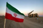 FILE PHOTO: An Iranian flag is pictured near in a missile during a military drill, with the participation of Iran’s Air Defense units, Iran October 19, 2020. Picture taken October 19, 2020. WANA (West Asia News Agency) via REUTERS