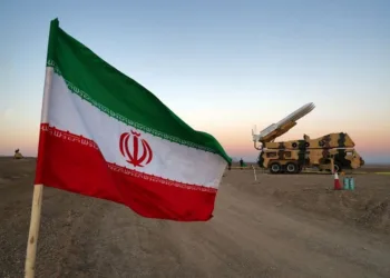 FILE PHOTO: An Iranian flag is pictured near in a missile during a military drill, with the participation of Iran’s Air Defense units, Iran October 19, 2020. Picture taken October 19, 2020. WANA (West Asia News Agency) via REUTERS