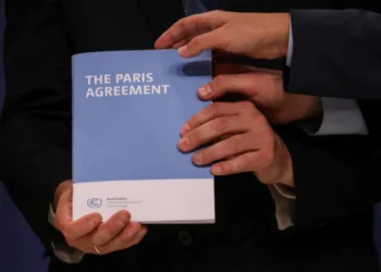COP25 High Level Climate Champion Gonzalo Munoz holds the copy of The Paris Agreement as he poses with Britain's former Minister of State for Energy and Clean Growth and newly appointed COP26 President, Claire Perry, Italian Environment Minister Sergio Costa and Spanish State Secretary of Environment Hugo Moran (not pictured) during the U.N. Climate Change Conference (COP25) in Madrid, Spain December 13, 2019. REUTERS/Susana Vera