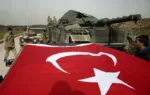 Turkish Army soldiers prepare their tanks and armoured personnel carriers at a staging area in the outskirts of the village of Sugedigi, Turkey, on the border with Syria, Monday, Jan. 22, 2018. The Turkish offensive on the Kurdish enclave of Afrin in Syria, codenamed Operation Olive Branch, started on Saturday, heightening tensions in the already complicated Syrian conflict and threatening to further strain ties between NATO allies Turkey and the United States. (AP Photo/Lefteris Pitarakis)