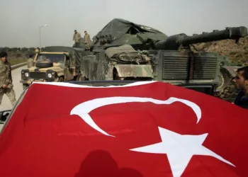 Turkish Army soldiers prepare their tanks and armoured personnel carriers at a staging area in the outskirts of the village of Sugedigi, Turkey, on the border with Syria, Monday, Jan. 22, 2018. The Turkish offensive on the Kurdish enclave of Afrin in Syria, codenamed Operation Olive Branch, started on Saturday, heightening tensions in the already complicated Syrian conflict and threatening to further strain ties between NATO allies Turkey and the United States. (AP Photo/Lefteris Pitarakis)