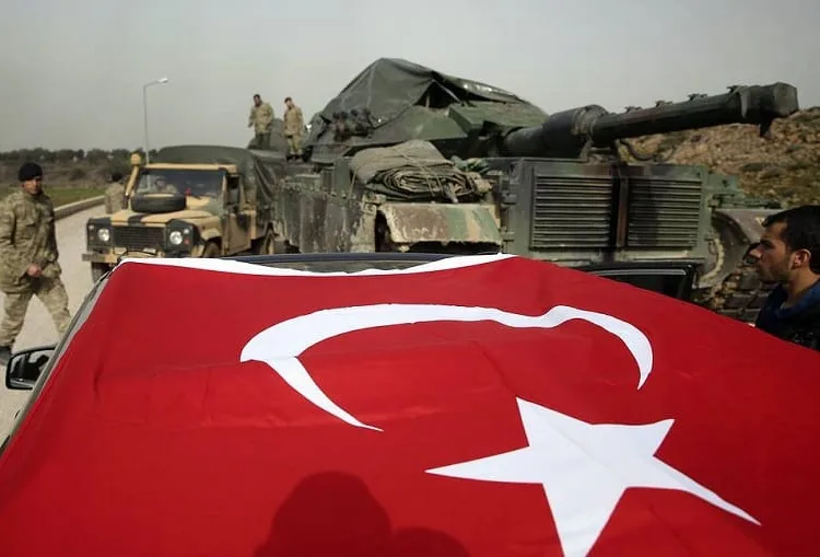 Turkish Army soldiers prepare their tanks and armoured personnel carriers at a staging area in the outskirts of the village of Sugedigi, Turkey, on the border with Syria, Monday, Jan. 22, 2018. The Turkish offensive on the Kurdish enclave of Afrin in Syria, codenamed Operation Olive Branch, started on Saturday, heightening tensions in the already complicated Syrian conflict and threatening to further strain ties between NATO allies Turkey and the United States. (AP Photo/Lefteris Pitarakis)