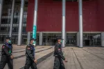 epa08352019 Security men guard outside of the convention center which was converted to the makeshift hospital and used to treat COVID-19 patients during the outbreak, in Wuhan, China, 09 April 2020. Wuhan, the epicenter of the coronavirus outbreak, lifted the lockdown on 08 April 2020, allowing people to leave the city after more than two months. According to Chinese government figures, over 2,500 people have died of Covid-19 in Wuhan since the outbreak began.  EPA-EFE/ROMAN PILIPEY