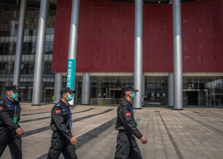 epa08352019 Security men guard outside of the convention center which was converted to the makeshift hospital and used to treat COVID-19 patients during the outbreak, in Wuhan, China, 09 April 2020. Wuhan, the epicenter of the coronavirus outbreak, lifted the lockdown on 08 April 2020, allowing people to leave the city after more than two months. According to Chinese government figures, over 2,500 people have died of Covid-19 in Wuhan since the outbreak began.  EPA-EFE/ROMAN PILIPEY