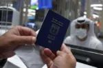 An Israeli man presents his passport for control upon arrival from Tel Aviv to the Dubai airport in the United Arab Emirates, on November 26, 2020, on the first scheduled commercial flight operated by budget airline flydubai, following the normalisation of ties between the UAE and Israel. (Photo by Karim SAHIB / AFP)