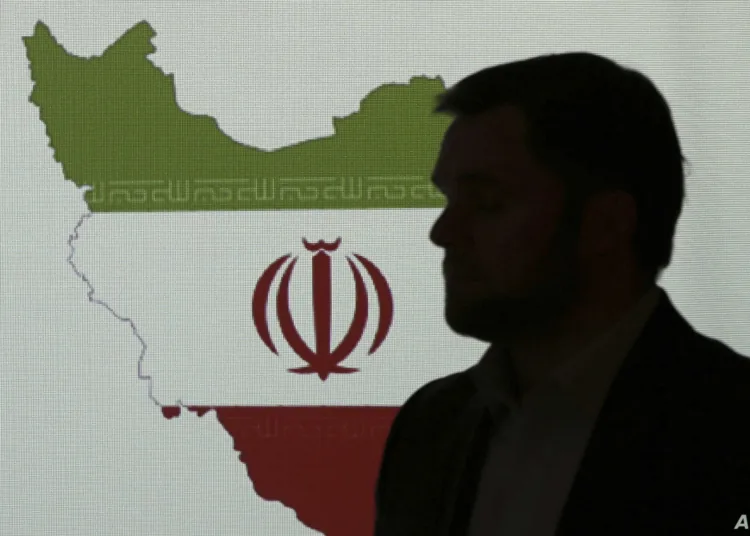 Stuart Davis, a director at one of FireEye's subsidiaries, stands in front of a map of Iran as he speaks to journalists about the techniques of Iranian hacking, Wednesday, Sept. 20, 2017, in Dubai, United Arab Emirates. A new report by FireEye, a cybersecurity firm, warned that a suspected group of hackers in Iran are targeting the aviation and petrochemical industries in Saudi Arabia, the U.S. and South Korea. (AP Photo/Kamran Jebreili)