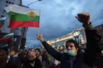 People shout slogans and wave Bulgarian flags during an anti-government protest near the parliament building in Sofia on October 16, 2020. - On the 100th day of protests in Sofia on October 16, several thousand people gathered to demand the resignation of Prime Minister Boyko Borisov and his conservative cabinet as well as the country's chief prosecutor. (Photo by Dimitar Kyosemarliev / AFP) (Photo by DIMITAR KYOSEMARLIEV/AFP via Getty Images)