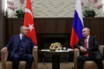 Russian President Vladimir Putin, right, and Turkish President Recep Tayyip Erdogan talk to each other during their meeting in the Bocharov Ruchei residence in the Black Sea resort of Sochi, Russia, Wednesday, Sept. 29, 2021. (Vladimir Smirnov, Sputnik, Kremlin Pool Photo via AP)