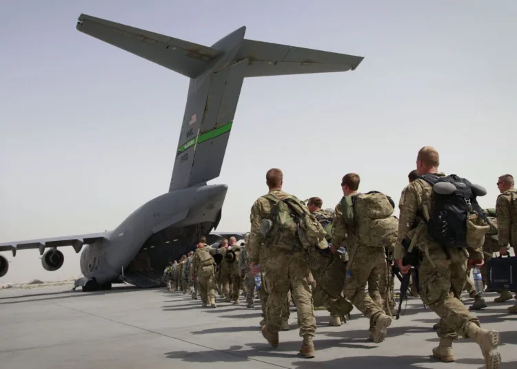 U.S. soldiers walk to get in to a U.S. military plane, as they leave Afghanistan, at the U.S. base in Bagram, north of Kabul, Afghanistan on Thursday, July 14, 2011. The first groups of the U.S. soldiers are leaving Afghanistan as President Barack Obama announced last month that he would pull 10,000 of the extra troops out in 2011 and the remaining 23,000 by the summer of 2012. (AP Photo/Musadeq Sadeq)