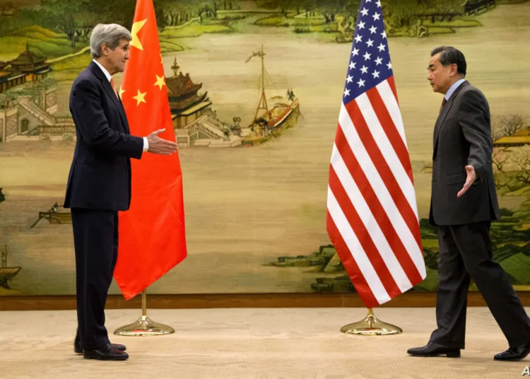 U.S. Secretary of State John Kerry, left, and Chinese Foreign Minister Wang Yi approach to shake hands after attending a news conference at the Ministry of Foreign Affairs in Beijing, Wednesday, Jan. 27, 2016. Kerry is on the final leg in his latest round-the-world diplomatic mission. (AP Photo/Jacquelyn Martin, Pool)