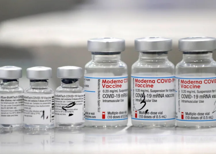 FILE PHOTO: Vials of coronavirus disease (COVID-19) vaccines of Pfizer-BioNTech and Moderna are seen in the town of Ricany near Prague, Czech Republic, February 25, 2021.  REUTERS/David W Cerny/File Photo/File Photo