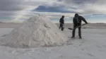 Employees shovel salt into mountains at the Salar de Uyuni (Uyuni Salt Flats) in Potosi, Bolivia, on Sunday, Dec. 11, 2016. Bolivia has the largest lithium deposits of any country, which are estimated to be about half of the world's supply. Photographer: Marcelo Perez del Carpio/Bloomberg