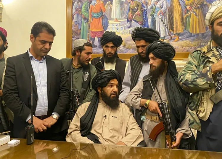 Taliban fighters take control of Afghan presidential palace after the Afghan President Ashraf Ghani fled the country, in Kabul, Afghanistan, Sunday, Aug. 15, 2021. Person second from left is a former bodyguard for Ghani. (AP Photo/Zabi Karimi)