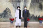 In this photo released by China’s Xinhua News Agency, Taliban co-founder Mullah Abdul Ghani Baradar, left, and Chinese Foreign Minister Wang Yi pose for a photo during their meeting in Tianjin, China, Wednesday, July 28, 2021. China's foreign minister has met with a delegation of high-level Taliban officials as ties between them warm ahead of the U.S. pullout from Afghanistan. (Li Ran/Xinhua via AP)