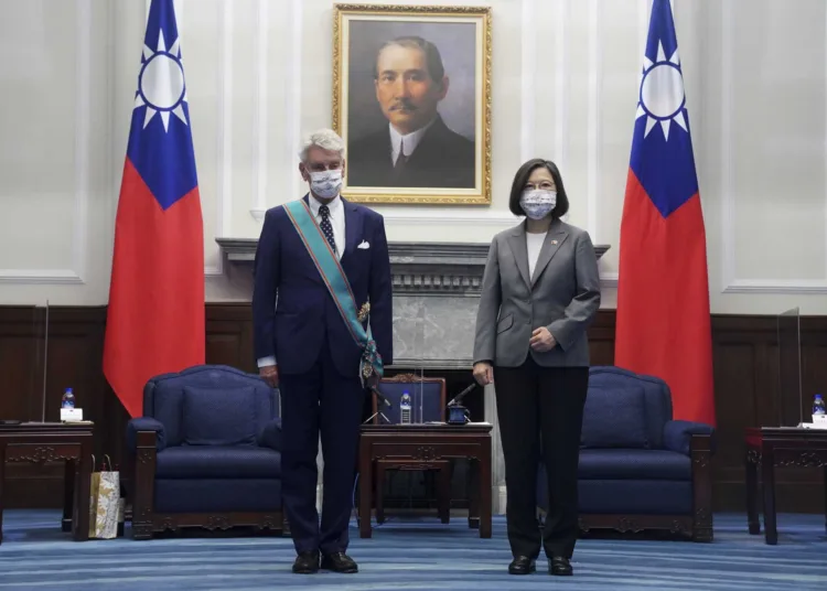 Taiwanese President Tsai Ing-wen, right poses for photos after awarding a medal of honor to Alain Richard, the head of the French Senate's Taiwan Friendship Group during a meeting at the Presidential Office in Taipei, Taiwan, Thursday, Oct. 7, 2021. A group of French senators led by Richard visiting Taiwan as part of a regular parliamentary exchange met with President Tsai on Thursday morning during a trip that comes in a particularly tense moment between Taiwan and China. (Pool Photo via AP)