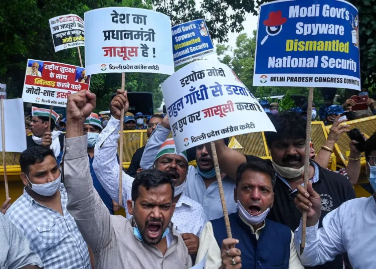 India's Congress party workers carrying banners and placards shout slogans as they take part in a demonstration against the Bharatiya Janata Party (BJP)led government and Indian Prime Minister Narendra Modi against alleged surveillance operation using the Pegasus spyware, in New Delhi on July 20, 2021. (Photo by Prakash SINGH / AFP) (Photo by PRAKASH SINGH/AFP via Getty Images)