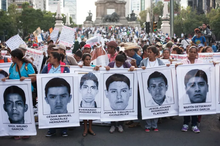 Parents of missing students lead a march through Mexico City during the 'Global Day of Action for Ayotzinapa' Wednesday, October 23, 2014.

The march was held to demand answers following the killing of three students and the disappearance of 43 more in the city of  Ayotzinapa, Guerrero, which is South West of Mexico City.  The students have been missing since September 26, 2014 and the local mayor and his wife are accused of ordering the kidnappings and killings. The local police are also accused of working with  the Guerreros Unidos cartel in the crimes. 

Since September 26, many mass graves have been located in the area surrounding the city, yet none of the remains found match the students. 

Colleges and Universities all across Mexico declared a strike for September 22 and 23, 2014 and protests in support of the missing students were held all over the world. 

(Brett Gundlock/Boreal Collective)