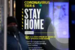 A Coronavirus Tier 4 Stay Home poster near King's Cross railway station in London, U.K., on Monday, Dec. 21, 2020. More than 16 million Britons are now required to stay at home as a lockdown came into force Sunday in London and southeast England, part of Boris Johnsons attempt to control a fast-spreading new strain of the coronavirus. Photographer: Jason Alden/Bloomberg via Getty Images