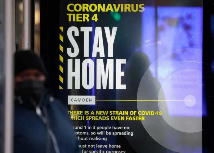 A Coronavirus Tier 4 Stay Home poster near King's Cross railway station in London, U.K., on Monday, Dec. 21, 2020. More than 16 million Britons are now required to stay at home as a lockdown came into force Sunday in London and southeast England, part of Boris Johnsons attempt to control a fast-spreading new strain of the coronavirus. Photographer: Jason Alden/Bloomberg via Getty Images