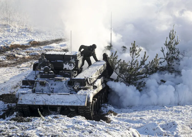 Soldiers work with their military vehicle at the Gozhsky training ground during the Union Courage-2022 Russia-Belarus military drills in Belarus. Russia has massed troops near the Ukraine border and has sent troops to exercises in neighboring Belarus but insistently denies that it intends to launch an offensive against Ukraine. (Vadzim Yakubionak, BelTA via AP)