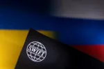 Swift logo is placed on Ukrainian's and Russian's flag colors in this illustration taken, Bosnia and Herzegovina, February 25, 2022. REUTERS/Dado Ruvic/Illustration