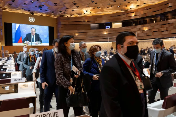 Ambassadors and diplomats walk out while Russian Foreign Minister Sergei Lavrov's (on screen) pre-recorded video message is played at the 49th session of the UN Human Rights Council at the European headquarters of the United Nations in Geneva, Switzerland March 1, 2022.  Salvatore Di Nolfi/Pool via REUTERS