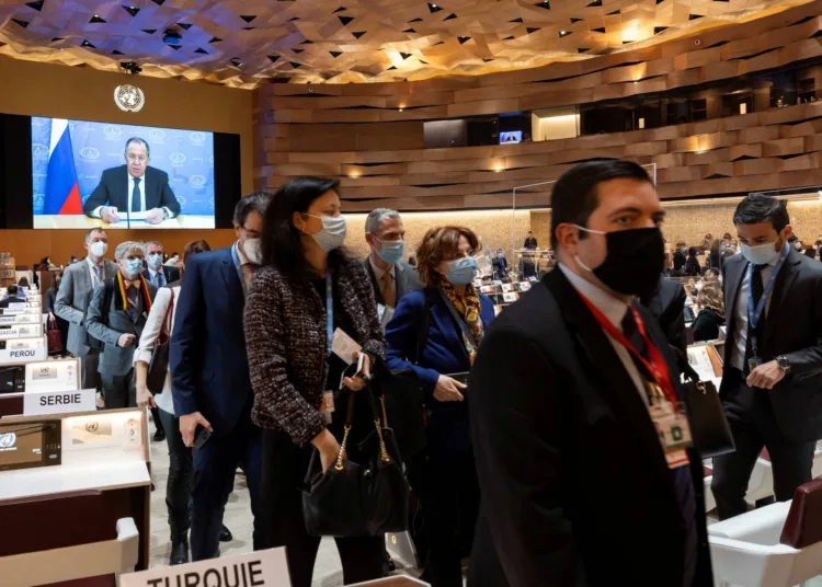 Ambassadors and diplomats walk out while Russian Foreign Minister Sergei Lavrov's (on screen) pre-recorded video message is played at the 49th session of the UN Human Rights Council at the European headquarters of the United Nations in Geneva, Switzerland March 1, 2022. Salvatore Di Nolfi/Pool via REUTERS